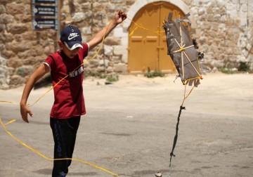 أطفال يلهون بطائرات ورقية في الساحة المغلقة للحرم الابراهيمي