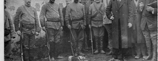 الصورة التي نشرتها السلطات العثمانية لتوثيق نجاحها في قتل حكيم أوغلو عام 1913، حيث يظهر مسجى إلى جوار مرتينته، وإلى يمين رفيق دربه ألان عثمان