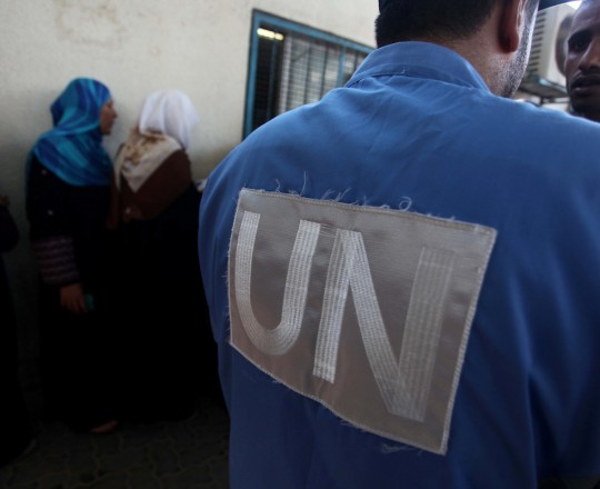 Palestinians wait to receive food supplies from a distribution centre of the United Nations Relief and Works Agency (UNRWA) in Gaza City 